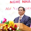 越南政府总理范明正在活动上发表讲话。