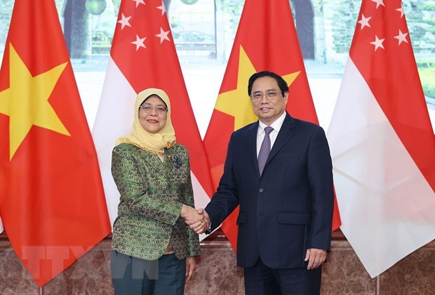 越南政府总理范明正会见新加坡总统雅各布。（图片来源：越通社）