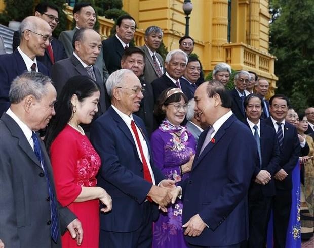 越南国家主席阮春福与各位退休教师们亲切握手。
