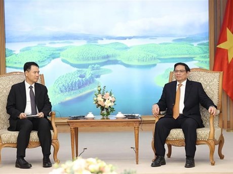 政府总理范明正会见老挝工贸部部长马来通·康马西。（图片来源：越通社）