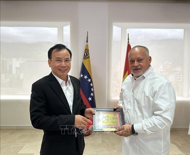 阮蓝副部长向委内瑞拉执政党统一社会主义党第一副主席迪奥斯达多·卡韦略送上纪念品。（图片来源：越通社）