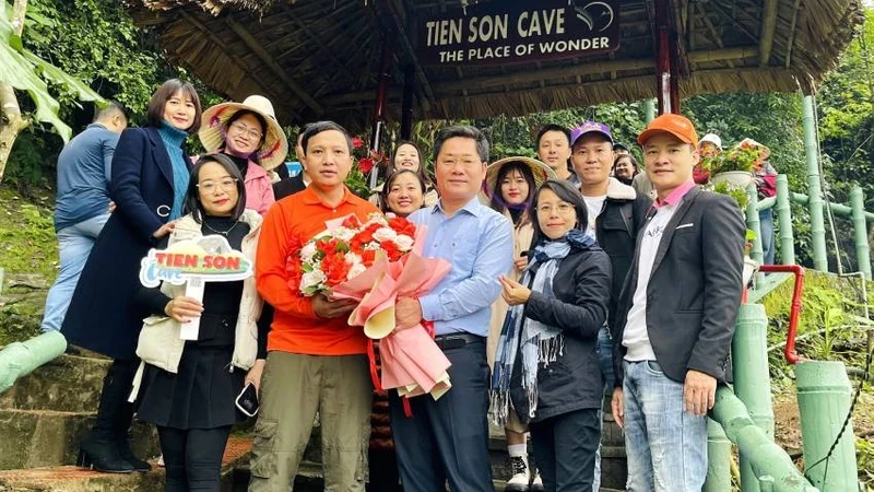 风芽-盖板旅游中心主任黄明胜在开放首日向游客送花。