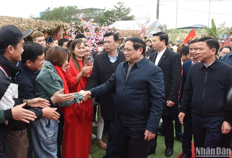 范明正总理与工人们亲切握手。