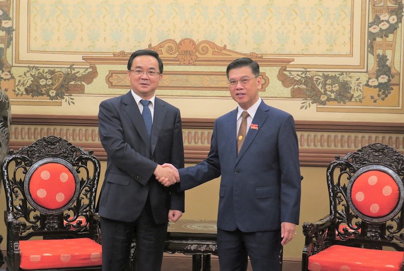 胡志明市人民委员会副主席阮文勇（右）和中国浙江省人大常委会副主任高兴夫亲切握手。