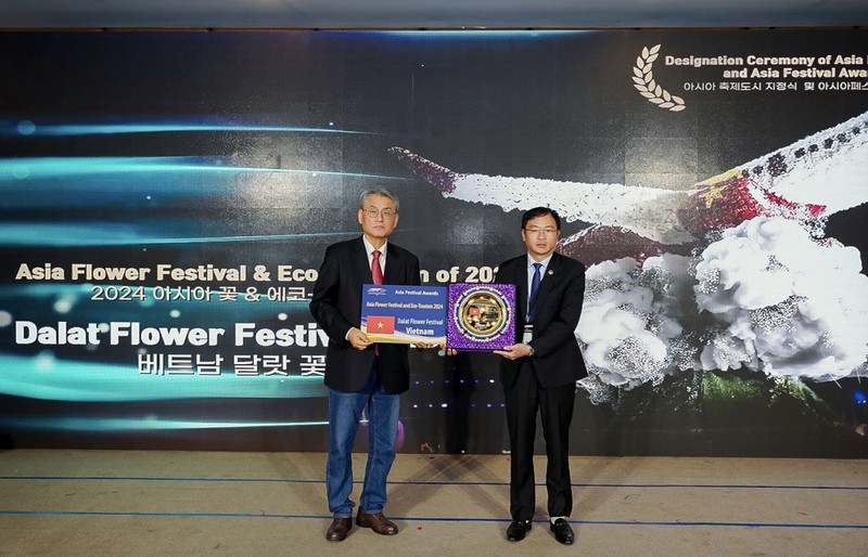 大叻市人民委员会主席邓光秀接受亚洲节庆城市奖的奖杯。