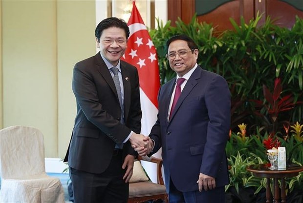 越南政府总理范明正会见新加坡副总理黄循财。（图片来源：越通社）