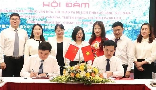 高平省文化体育与旅游厅与中国广西百色市文化广电体育和旅游局领导签署合作备忘录。（图片来源：越通社） 