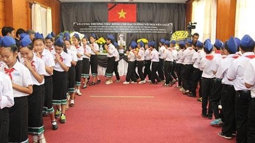 老挝首都万象阮攸学校103名学生前来吊唁武元甲大将。 (Photo: 图片来源：人民报网)
