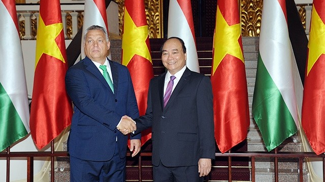 越南政府总理阮春福与匈牙利总理维克托•欧尔班亲切握手。