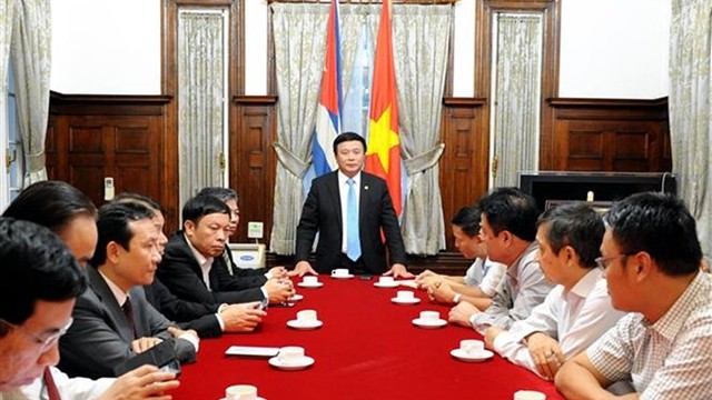 阮春胜同志与越南驻古巴大使馆干部和人员交谈。（图片来源：越通社）