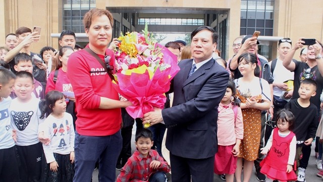 芒街市领导给外国游客赠送鲜花。（光寿 摄）