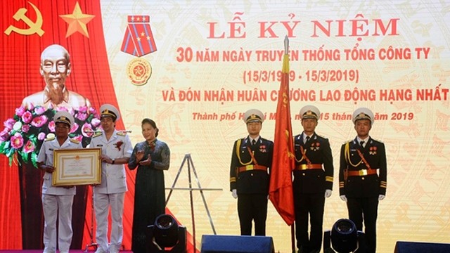 国会主席阮氏金银代表党、国家领导人授予西贡新港总公司的一级劳动勋章。