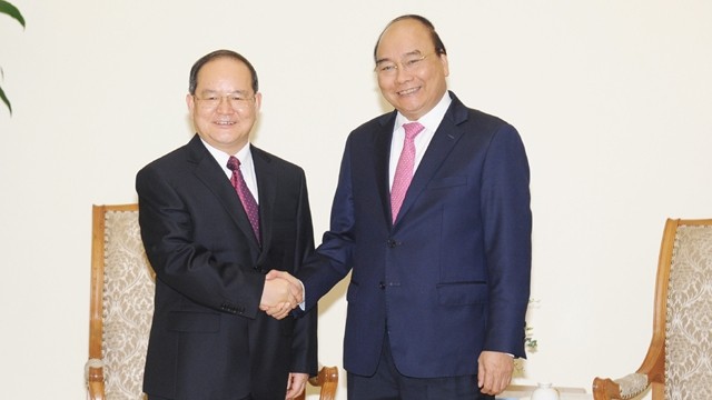 阮春福总理与中国广西壮族自治区党委书记鹿心社握手。