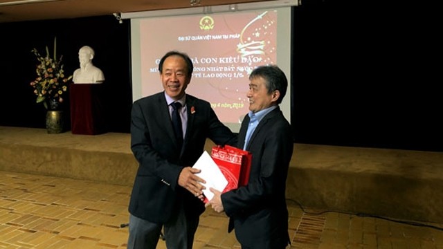 阮涉大使向旅居法国越南人协会主席赠送纪念品。（图片来源：人民报网）
