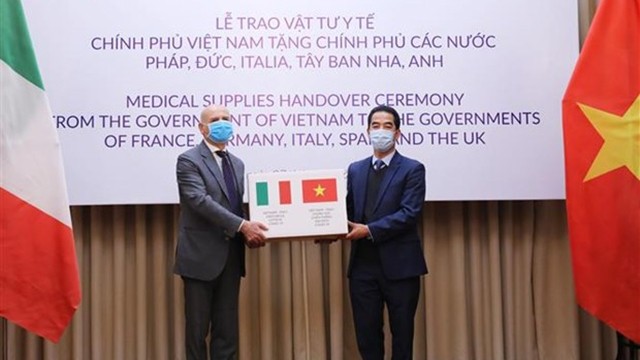 越南外交部副部长苏英勇向意大利亚驻越南大使交付防疫物资。（图片来源：越通社）