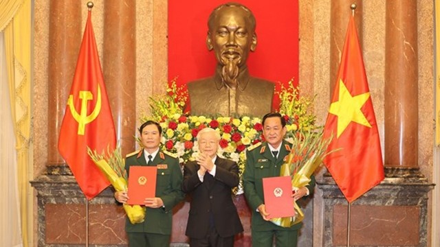 越共中央总书记、国家主席阮富仲向中将晋升上将军衔的军官颁发命令状。