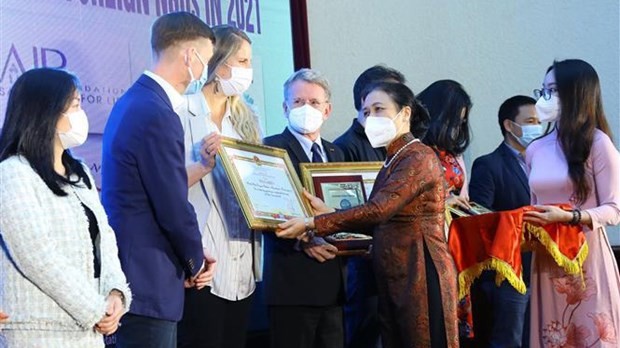 越南友好组织联合会主席阮芳娥向境外非政府组织授予奖状。（图片来源：越通社）