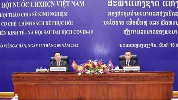 越南国会主席王廷惠与老挝国会主席赛宋蓬·丰威汉共同主持研讨会。（图片来源：越通社）