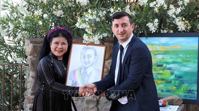 画家文杨成（左）与特拉西梅诺湖畔帕西尼亚诺市长桑德罗·帕斯夸里合影。（图片来源：越通社）